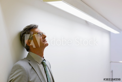 Free: Tired mature corporate businessman leaning against wall - nohat.cc