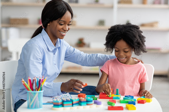 Free: Pretty black kid and child development specialist playing with ...